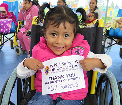 A child with disabilities joyfully holds a 