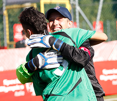 Soccer players sharing the joy of celebrating a win after a game.