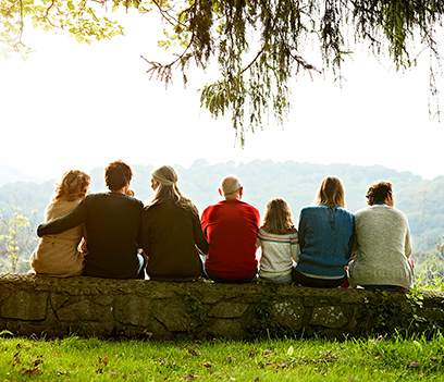 Family members sitting outdoors enjoying nature.