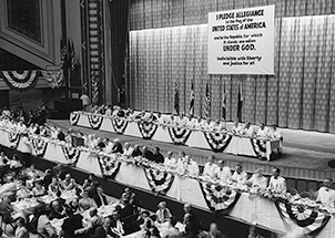 People are gathered in an assembly hall 1954