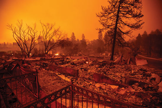 Rubble lines a residential lot after the Camp Fire