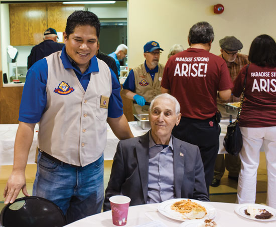 Ronald Galla, a member of Council 7773, greets parishioners 