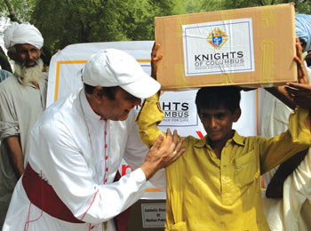 Bishop Andrew Francis of Multan, Pakistan, gives a box of relief goods to a Pakistani boy. Bishop Andrew Francis of Multan, Pakistan, gives a box of relief goods to a Pakistani boy.