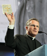 Archbishop Timothy Broglio of the Archdiocese for Military Services, USA, holds up a copy of “Armed With the Faith” at the Aug. 4 business session. To date, more than 500,000 copies of the Knights of Columbus prayer book for U.S. military personnel have been printed. Archbishop Timothy Broglio of the Archdiocese for Military Services, USA, holds up a copy of “Armed With the Faith” at the Aug. 4 business session. To date, more than 500,000 copies of the Knights of Columbus prayer book for U.S. military personnel have been printed.