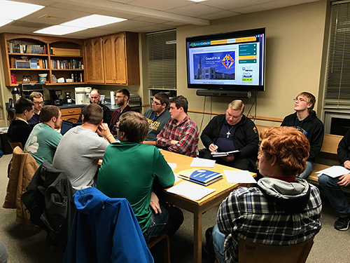 A college council sitting at a table 