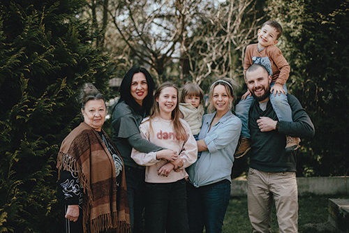 From left, Tatiana, Inna and Eleonora are pictured with Marta and Dominik Kołodziej and their two children, Dominika and Nikodem, outside their home in Kraków. Photo by Sebastian Nycz