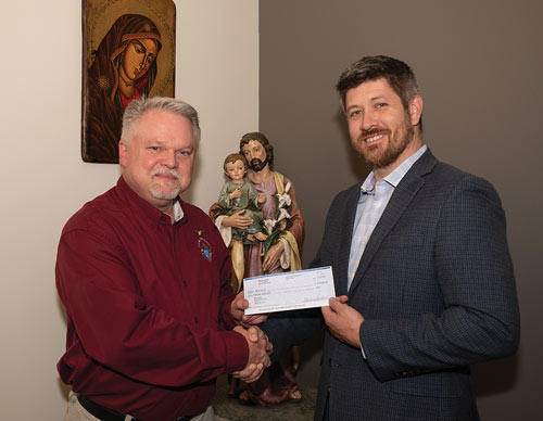 Texas State Life Director Tom Clark delivers a check for $30,000 to Aaron Fowler, Birth Choice’s executive director