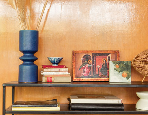 Shelves with books and a small painting