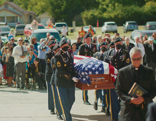 Soldiers from the U.S. Army’s 1st Cavalry Division carry the remains of Father Emil Kapaun into St. John Nepomucene Church