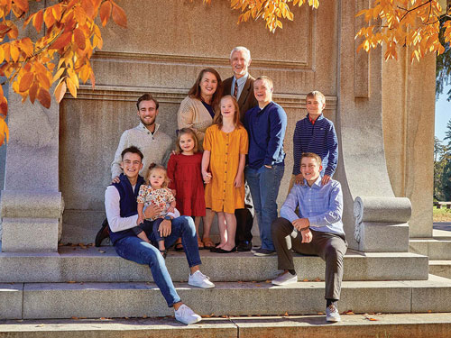 Jeff and Sonia McGarrity stand together with their eight children at Fairmount Cemetery in Denver in the fall of 2021. (Photo by Patrick Sola)