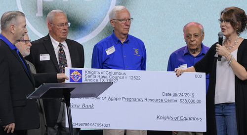 Grand Knight Harry Larkin (left) and other members of Santa Rosa de Lima Council 12522 in Andice, Texas, present a donation to Jo Markham, executive director of Agape Pregnancy Resource Center, in 2019 for the purchase of an ultrasound machine. The council recently made another donation to Agape that was boosted 20% through the new ASAP program.