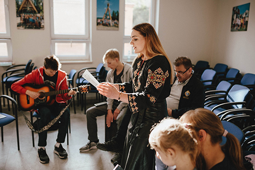 People take part in a music class at the Blessed Michael McGivney House in June. (Photo by Sebastian Nycz)