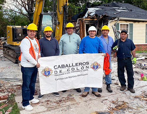 Members of Los Martires Mexicanos Council 14609 in Rogers, Ark., prepare to tear down the Leon family’s house June 9. The Knights’ work saved the family thousands of dollars and enabled them to rebuild on the same site.