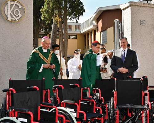 Two Knights are aiding a disable adult and a child to accustom with their new wheelchairs.
