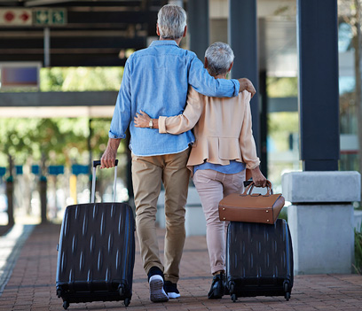 Traveling retired couple holding each other