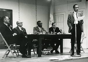 An individual giving a speech on a conference