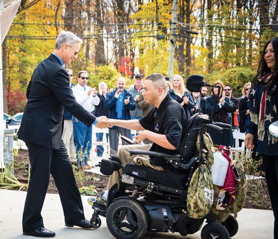Capt. Luis Avila shakes hands with actor Gary Sinise
