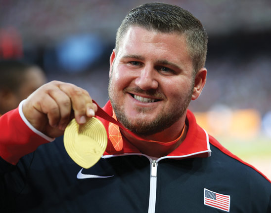 Joe Kovacs shows his gold medal during the awards ceremony