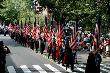 Following the parade's first division, the 28 U.S. flags represent the colors of the nation throughout its history.